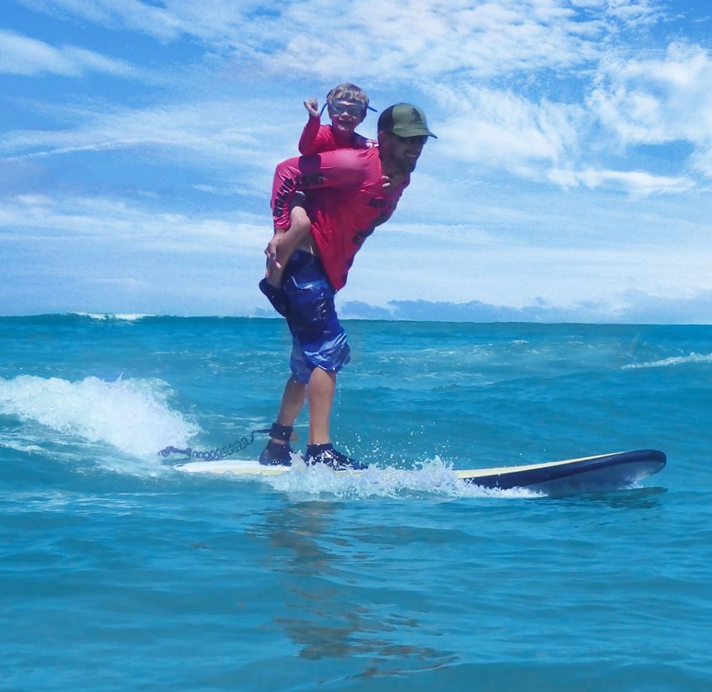 surf instructor maui hawaii with kid doing shakra